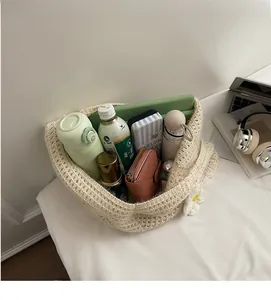 Macro view of beige knit tote bag showing large storage capacity with daily essentials