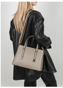 Lychee-patterned khaki leather tote bag shown on model with silver metal hardware and strap