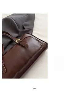 Close-up of deep brown matte leather bag with golden metal buckle and retro textures
