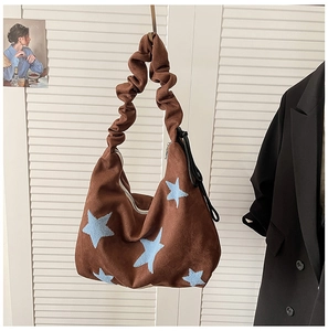 Brown faux suede shoulder bag with blue star embroidery and ruffled strap details