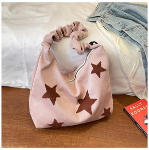 Pink faux suede shoulder bag featuring a star patch and scrunchie-style pleated handle