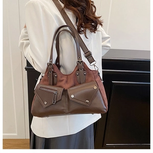 Brown vintage motorcycle bag with twin pockets and studs shown being worn by a model