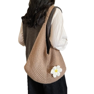 Brown knit hobo shoulder bag with a white daisy floral accent for casual daily commute