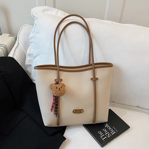 Vintage cream faux leather tote bag with brown trim and cute bear charm pendant