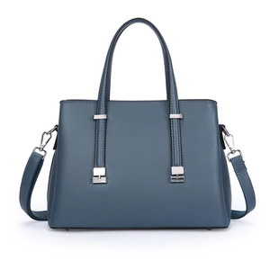 Minimalist grey-blue tote bag with twin handles and silver metal accents on white background