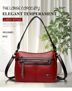 Detail of red lychee grain texture shoulder bag with gold kangaroo logo and brown trim