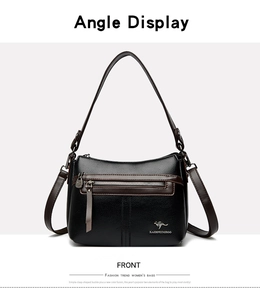 Macro shot of black lychee grain leather crossbody bag with silver zipper and logo detail