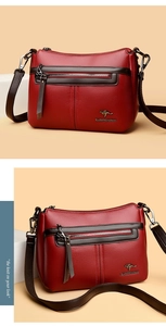 Macro detail of red litchi texture leather with brown strap and metallic kangaroo logo