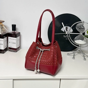 Deep red crocodile texture bucket bag with woven details and pearl charms for women