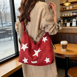Large red suede hobo bag with white star embroidery and wide strap for women