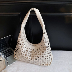 Chic cream-colored crescent bag with silver rivets and minimalist office aesthetic