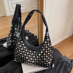 Mirror view of a black punk rivet shoulder bag with silver studs and crescent shape