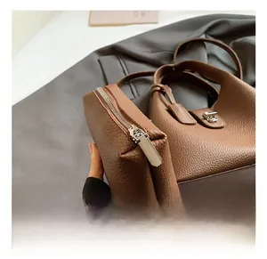 Detailed macro view of dark brown pebbled leather texture and silver zipper hardware