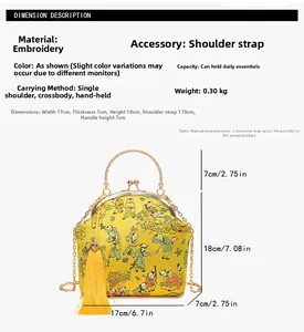 Detail view of yellow embroidered evening bag with traditional patterns and chain strap