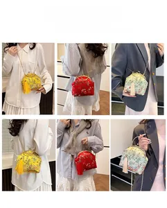 Detail of Chinese style evening bags with embroidery, tassels, and metal chains