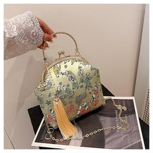 Macro shot of traditional Chinese silk embroidery evening bag with golden tassels