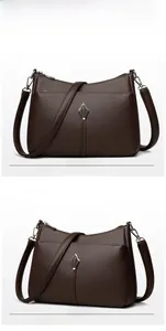Detail of dark brown litchi textured leather shoulder bag with metal rhombus ornament