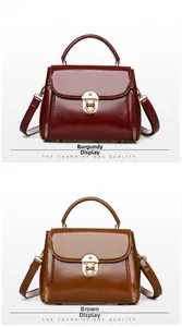 Detail of high-gloss leather handbags in burgundy and brown with golden push-locks