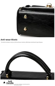 Detail of glossy black handbag showing golden bottom rivets and soft padded handle