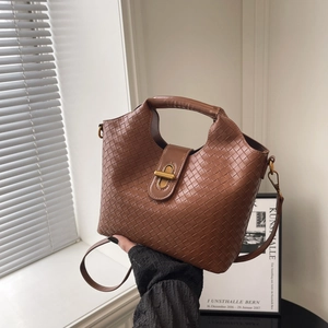 Brown woven leather bucket bag with gold metal lock and shoulder strap in retro style