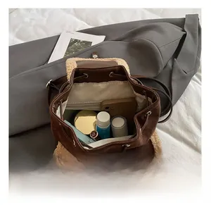 Detail show of spacious interior of the brown fleece backpack with phone and cosmetics