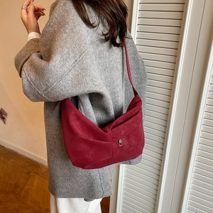 Detail view of burgundy frosted shoulder bag with bow-knot pleats and metal buckle