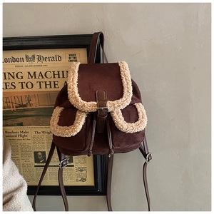 Detail of vintage sherpa-trimmed corduroy backpack with drawstring and flap closure