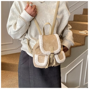 Detail view of mini beige faux suede backpack with white faux shearling trim and drawstring