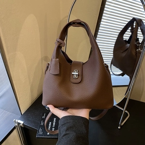 Dark brown pebbled leather bucket bag with silver twist lock and crossbody strap