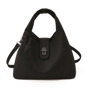 Modern minimalist black pebbled leather bucket bag with silver twist lock on white background