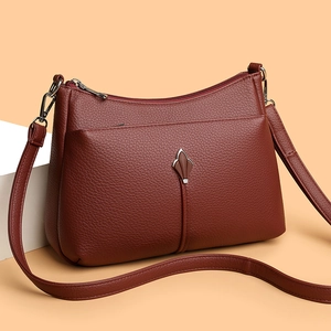 Deep burgundy pebbled leather crossbody bag with silver hardware and trapezoid design