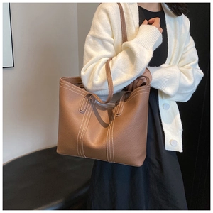 Brown grainy leather tote bag with white contrast stitching detail and large capacity