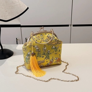 Yellow silk evening bag with traditional kids pattern, gold ring handle and tassels