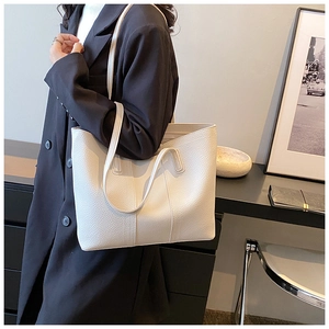 Detail of white lychee pattern leather tote bag with vertical stitching and large capacity