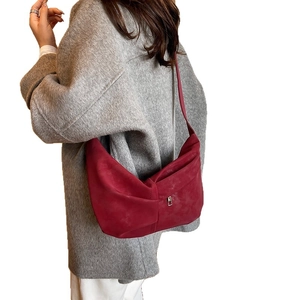 Retro red matte crescent shoulder bag for women with half-moon shape and pleated texture