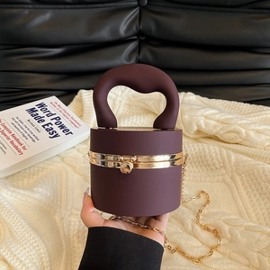 Deep purple cylindrical evening bag with heart handle and golden metal frame