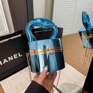Metallic blue cylinder handbag with gold hardware and chain strap for evening events