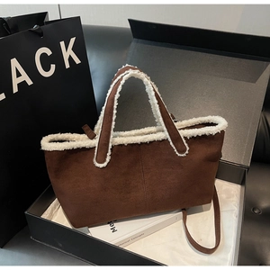 Detail of suede tote bag with lamb wool trim in a gift box with a shoulder strap