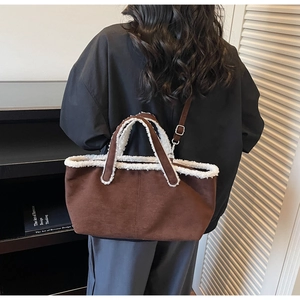 Brown suede tote bag with faux shearling trim shown worn as a crossbody bag for fall