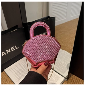 Pink rhinestone acrylic evening bag with structured top handle and gold chain strap