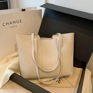 Minimalist creamy white lychee leather tote bag in a luxury gift box packaging