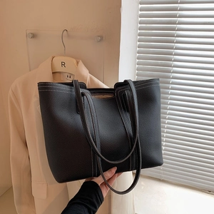 Fashionable black pebbled leather tote bag with contrast white stitching and large capacity