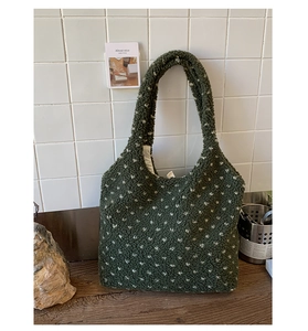 Detail of dark green polka dot teddy tote bag with plush texture and sturdy shoulder strap