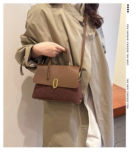 Detail shot of vintage patchwork crossbody bag in brown suede and leather texture