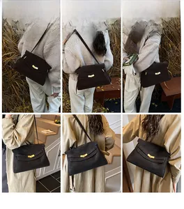 Vue lifestyle du sac cabas vintage en cuir avec boucle dorée porté à l'épaule