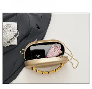 Interior capacity of gold acrylic clutch bag with metal chain for phone and cosmetics