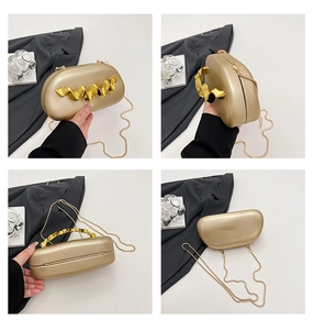 Detail views of gold hard shell evening clutch bag with wavy metal handle and snake chain