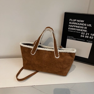 Brown suede tote bag with white faux shearling trim and slim shoulder straps for winter