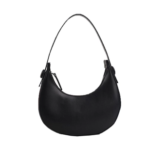 Minimalist black leather crescent bag with smooth matte finish and sleek curved silhouette