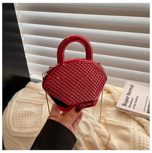 Red acrylic evening bag with textured mirror finish and golden chain strap